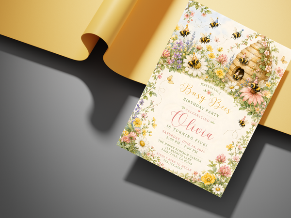 Watercolor honey bee birthday invitation with an elegant floral garden border, natural hive imagery, daisies and soft yellow, pink and green tones.
